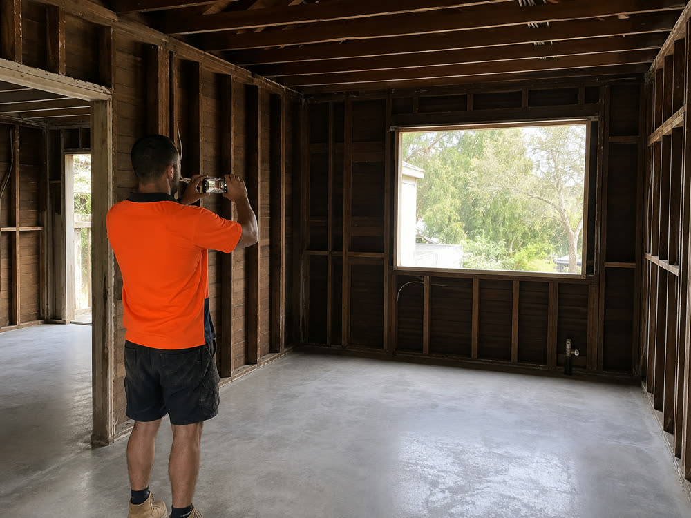 An emptied room with a clean swept concrete floor at the end of a clearance